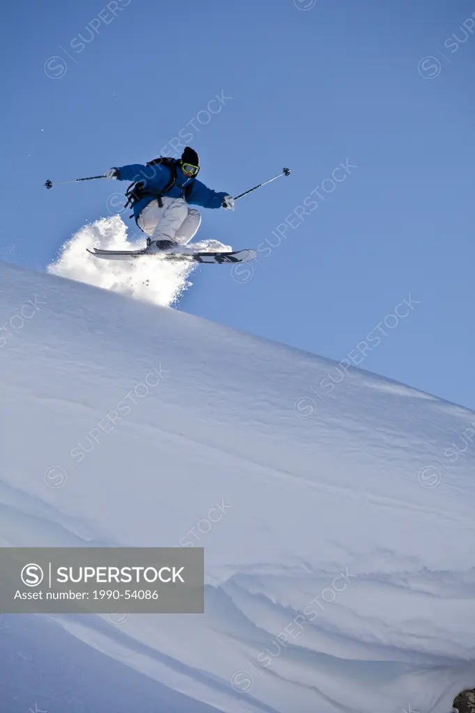 A young male skier catching air off a cornice, Healy Pass, Sunshine Village Backcountry, Banff National Park, Alberta, Canada