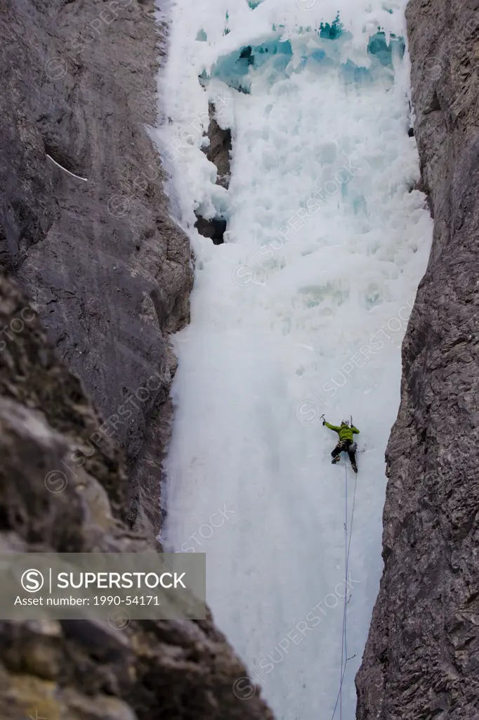 An ice climber moving up mountain at Ghost River, Alberta, Canada