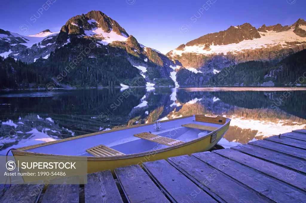Rowboat at the Alpine Club of Canada cabin dock on Lake Lovely Water at dawn, Tantalus Provincial Park, British Columbia, Canada.