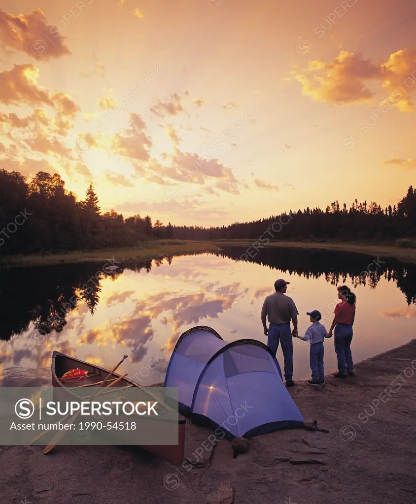 Family camping on riverbank, Whiteshell River, Whiteshell Provincial Park, Manitoba, Canada
