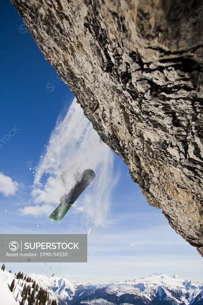 A male skier airs a cliff while on a cat ski trip, Monashees, Vernon, Britsh Columbia, Canada