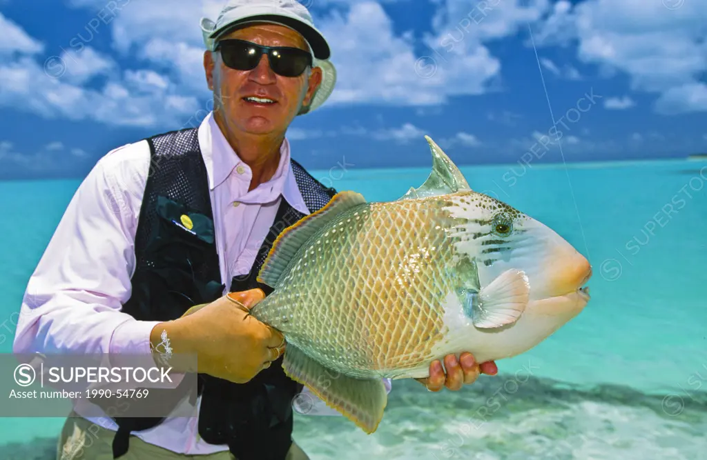 Man holding parrot fish, Seychelle Islands, Republic of Seychelles