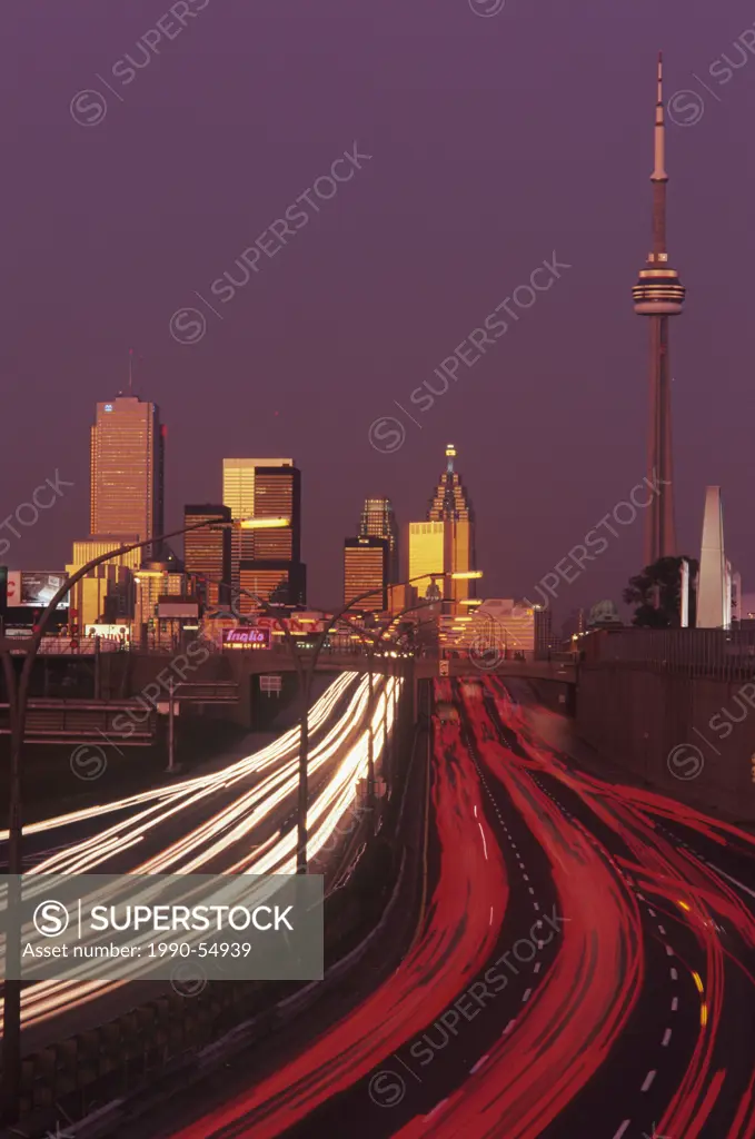 Dusk and rush hour traffic with skyline of Toronto, Ontario, Canada.
