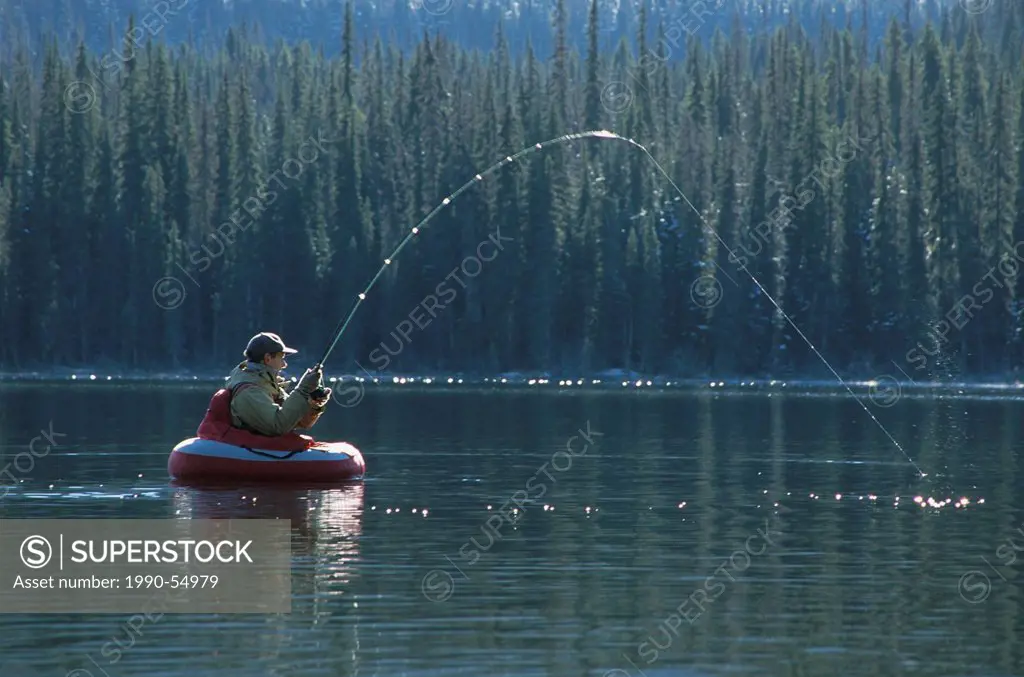 Flyfishing for trout from float_tube, Dennis lake, Bulkley Valley, British Columbia, Canada.