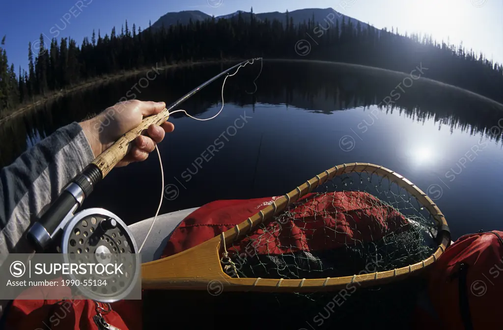 Flyfishing for trout from float_tube, Llama lake, Smithers, British Columbia, Canada.
