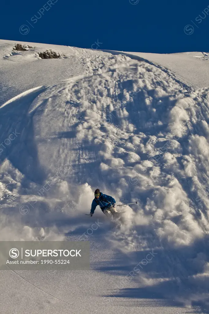 A young male skier outrunning his slough Healy Pass, Sunshine Village Backcountry, Banff National Park, Alberta, Canada