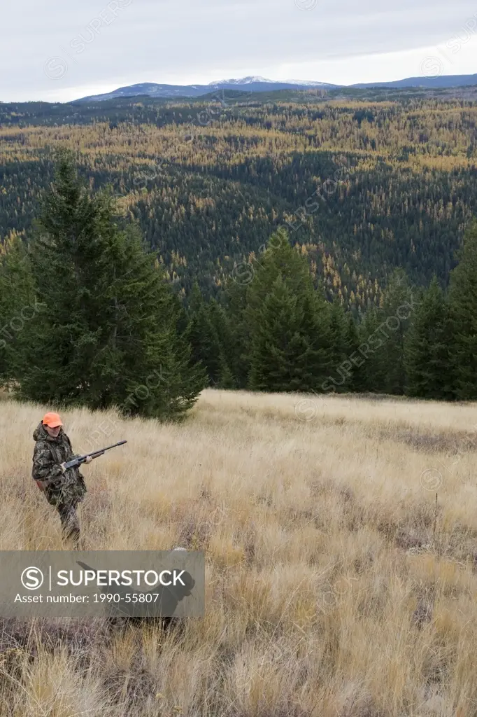 Woman and dog hunting together in British Columbia, Canada