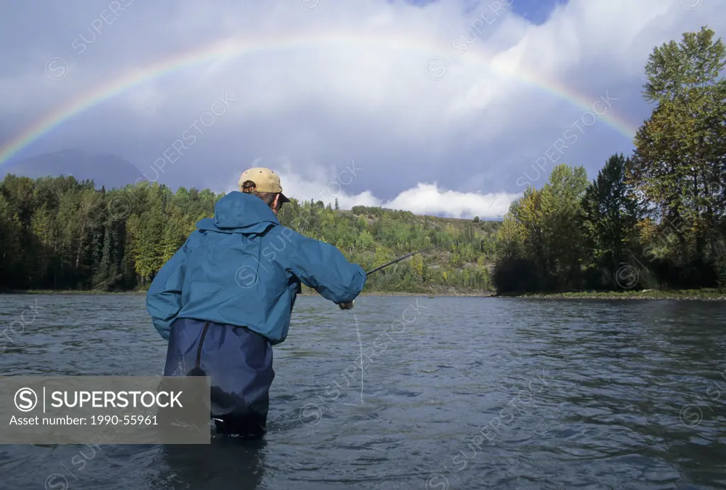 Flyfishing under rainbow, Bulkley river, British Columbia, Canada.