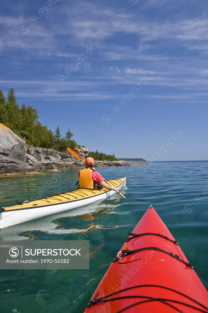 Kayaking in Georgian Bay along Niagara Escarpment near Tobermory, Bruce Penninsula, Ontario, Canada.