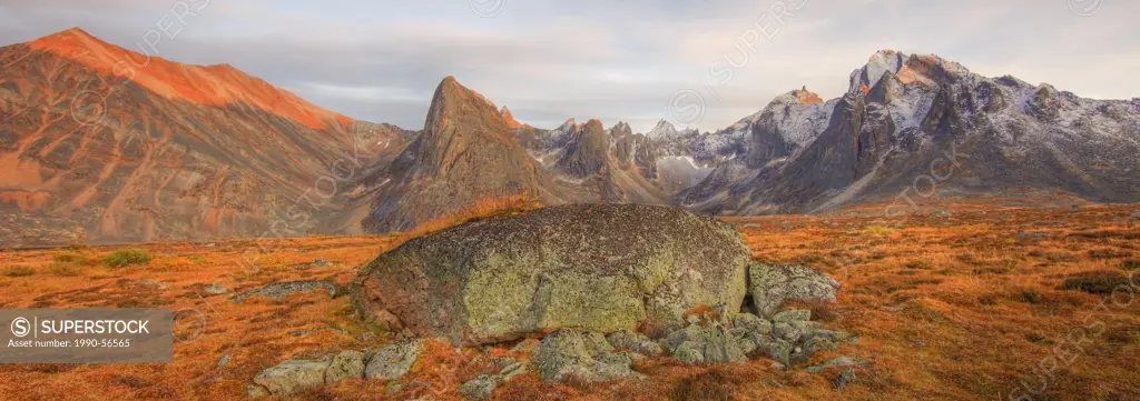 Alpenglow on Mount Monolith, Yukon. Autumn in the Tombstone Valley, Tombstone Territorial Park, Yukon. Large glacial erratic or boulder on valley floo...