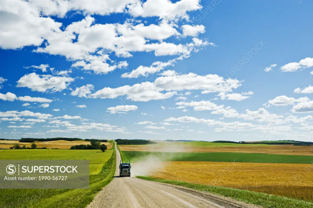A truck on a country road with farmland on either side of the road, Tiger Hills, Manitoba, Canada