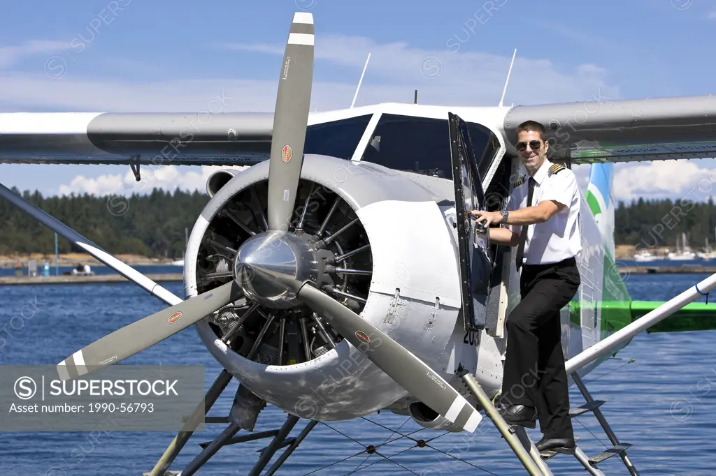 A pilot with his Beaver aircraft, about to takeoff out of Nanaimo´s inner harbour on a scheduled flight with Harbour Air. Nanaimo, Central Vancouver I...
