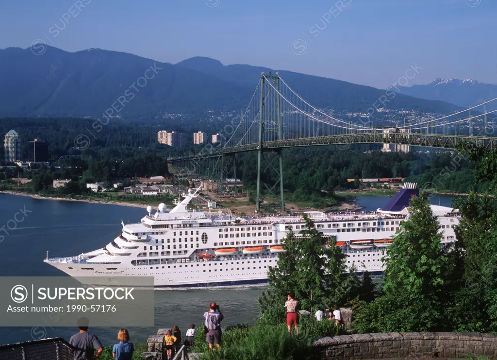 Passenger cruise ship in the Burrard Inlet passing under the Lions Gate Bridge, Vancouver, British Columbia, Canada.
