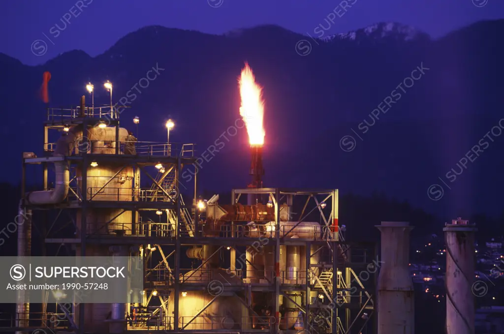 Oil refinery in Burnaby, North Shore mountains beyond, Vancouver, British Columbia, Canada.