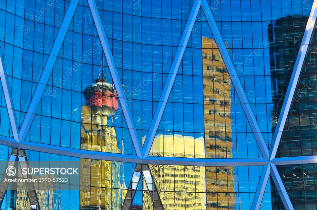 Calgary Tower and skyline reflected in new Bow Tower, Calgary, Alberta, Canada