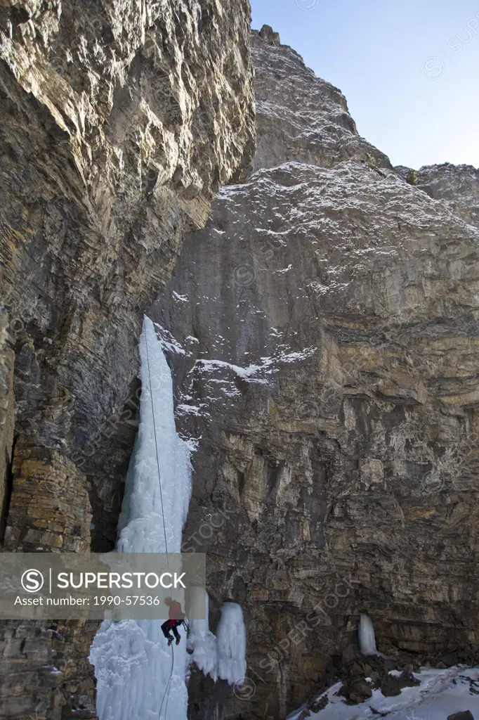 A man rappelling after free soloing the, Fang & Fist WI5, Ghost River Valley, Alberta, Canada