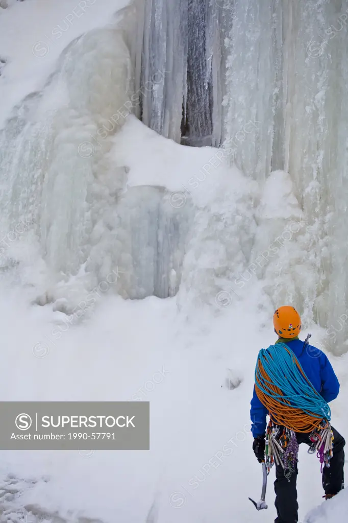 A young man gets ready to climb La Mer de Glace 4+, St Raymond, Quebec, Canada