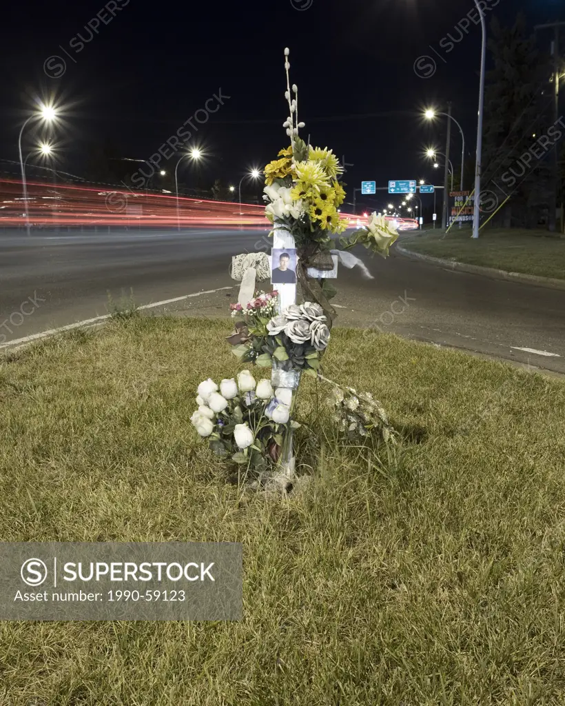 Road side cross at urban intersection memorial for traffic death.