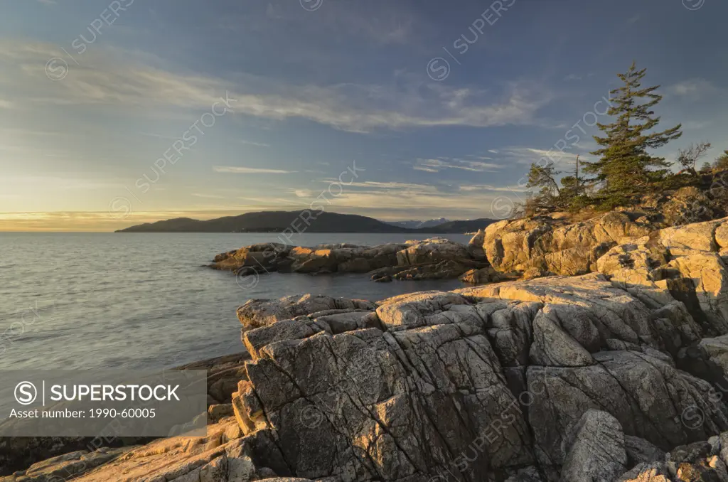 Sun hitting the rock formations on the shore of Lighthouse Park in West Vancouver, British Columbia, Canada.