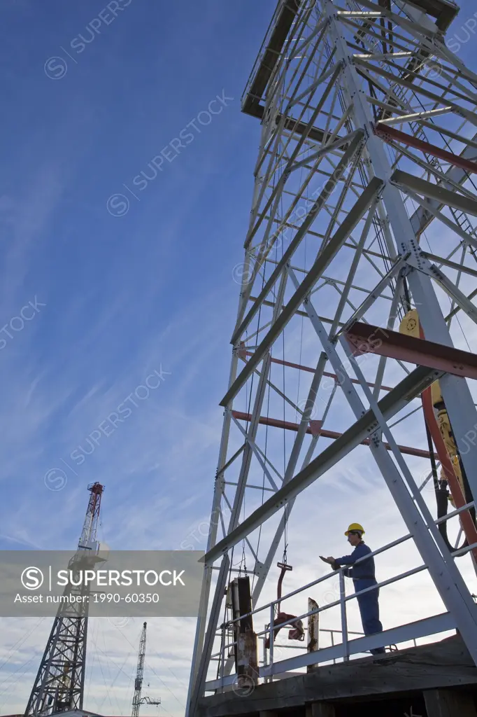 Oil rig worker on drilling platform.