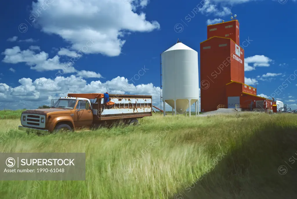 wind blown grass, old truck, grain elevator, Stoughton, Saskatchewan, Canada