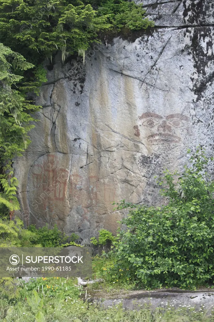 Images of a face and seven coppers, painted in red ochre on a vertical rock wall were an ´advertisement´ for a local chief from the Tyee area of the l...