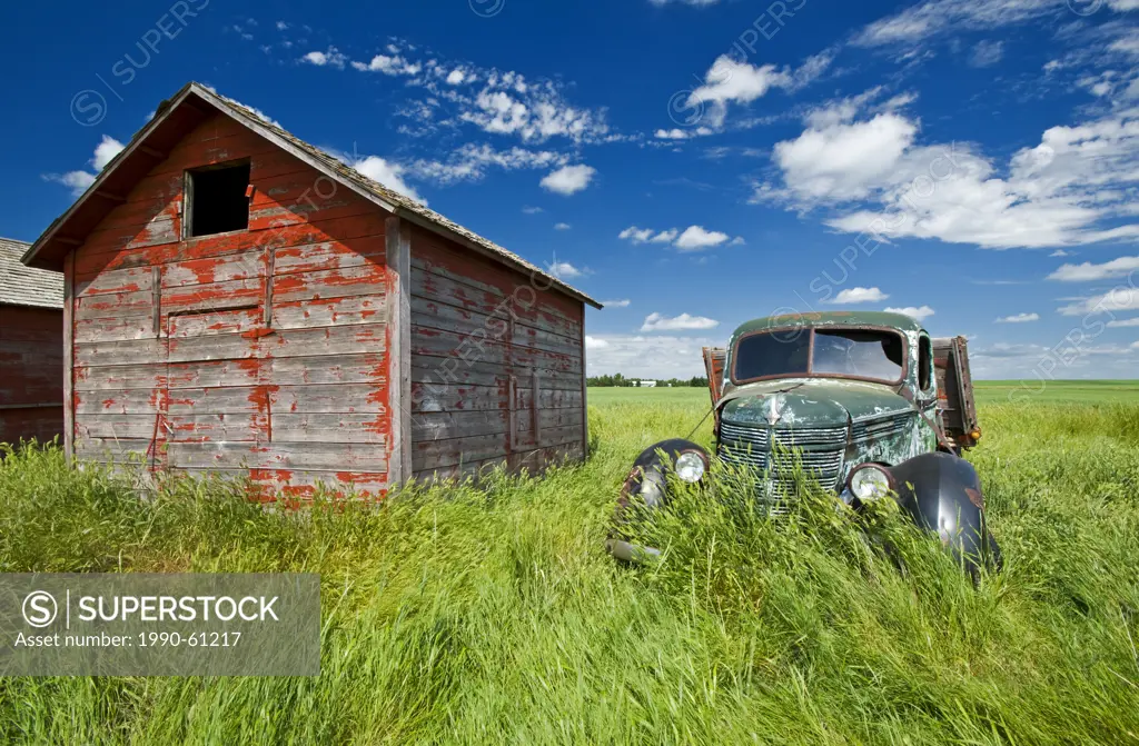 old farm truck beside grain bin, near Hazenmore, Saskatchewan, Canada