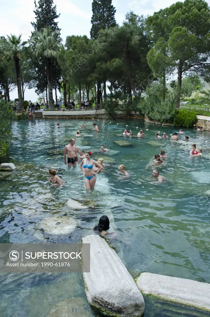 Pamukkale hot springs swimmers amongst columns, in Denizli Province in southwestern Turkey