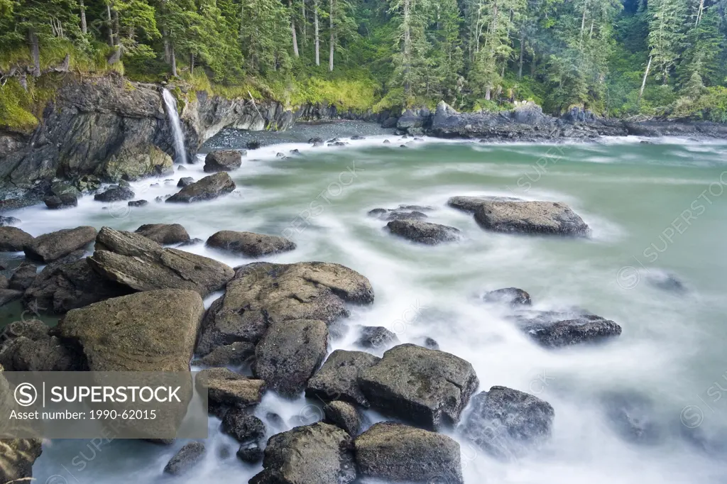 A small creek along the Juan De Fuca Trail falls into the Pacific Ocean in the early morning at Sombrio Beach, Vancouver Island, British Columbia, Can...