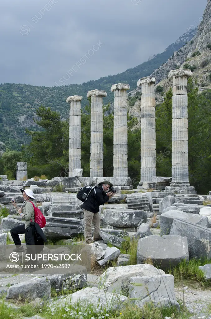 Visitors at Priene, ruins of an ancient Greek city of Ionia at the base of an escarpment of Mycale, 25 kilometres 16mi from ancient Miletus, Turkey