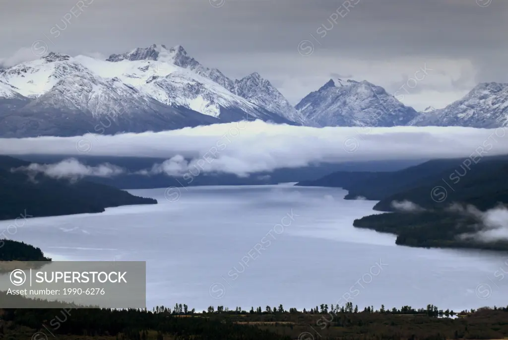 Glacial lake with fog forming in valley and Mt  Moore in distance, Tatlayoko Lake, British Columbia, Canada