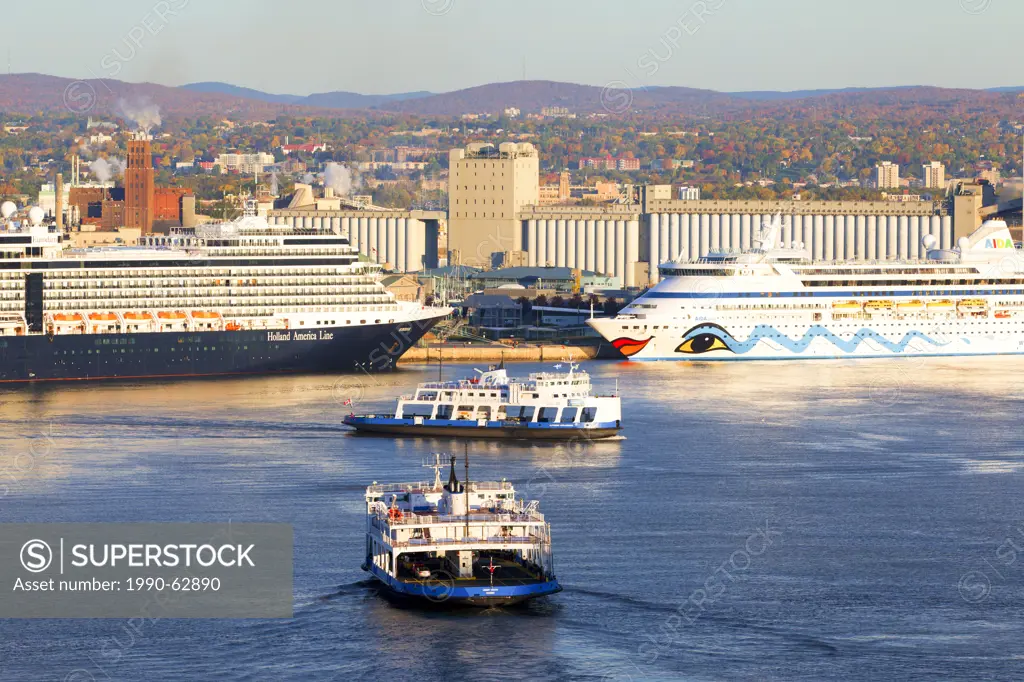 Car ferries crossing the St. Lawrence River in front of cruise ship docked at Quebec City, Quebec, Canada
