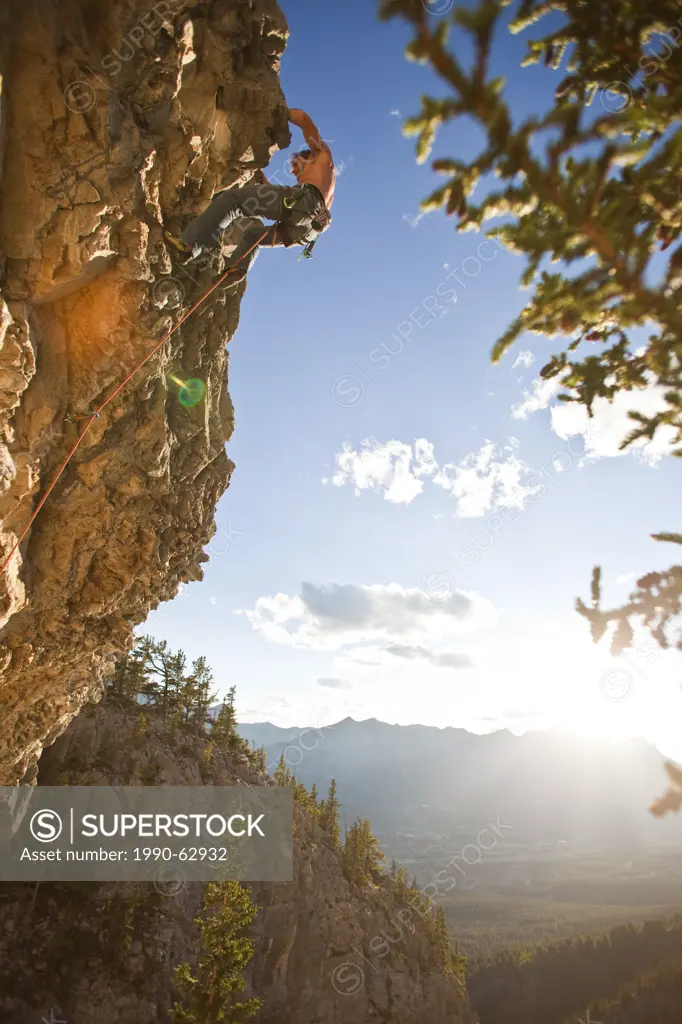 A man rock climbs the sport route Peyto Powder 12a, Echo Canyon, Canmore, Alberta, Canada