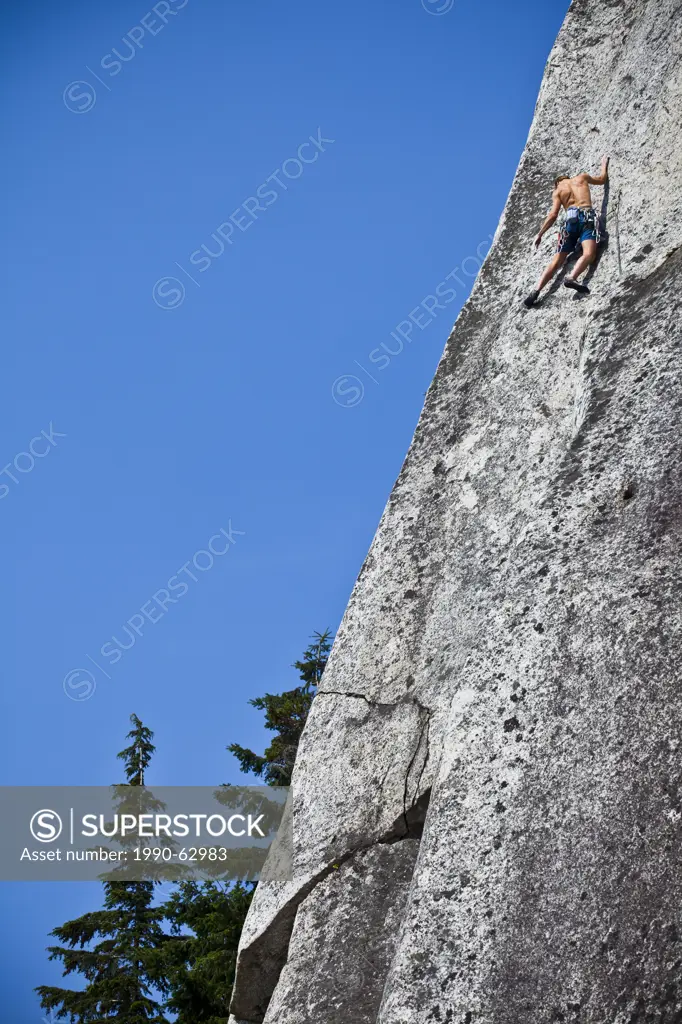 A strong male climber climbing Crescent Crack 10d, Squamish, BC