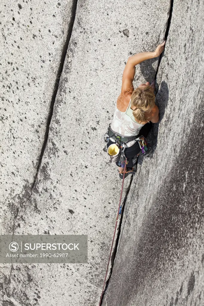 A strong female climber climbing Crescent Crack 10d, Squamish, BC