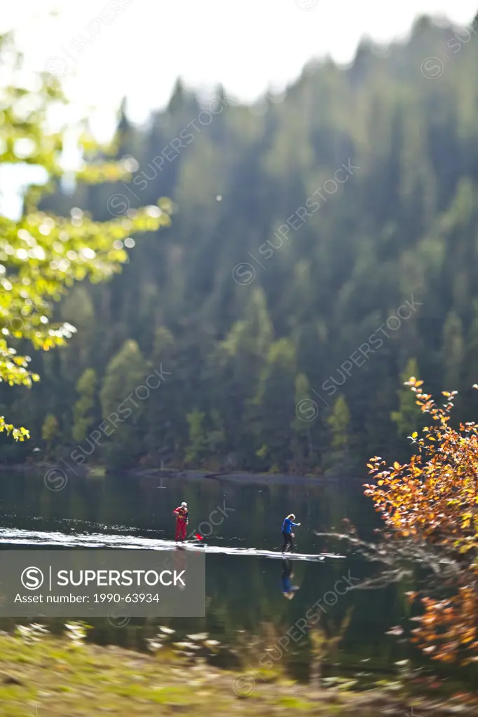 Two men paddleboarding on the Quesnel River in Likely, BC