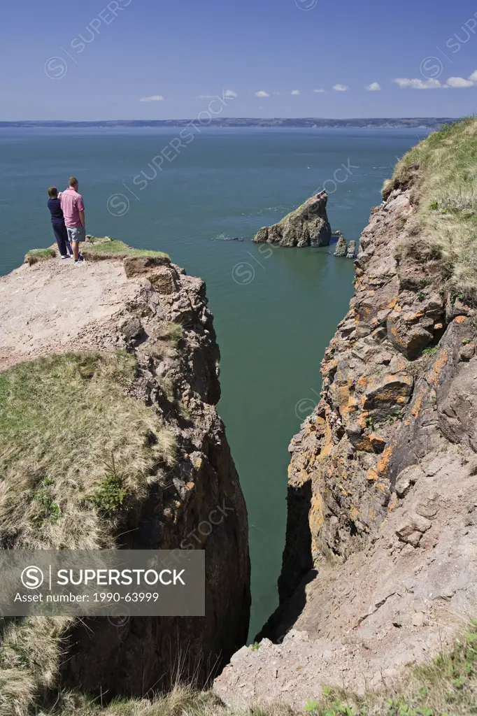 Hikers view the rock formations at the Cape Split hiking trail along Nova Scotia´s Bay of Fundy coast.
