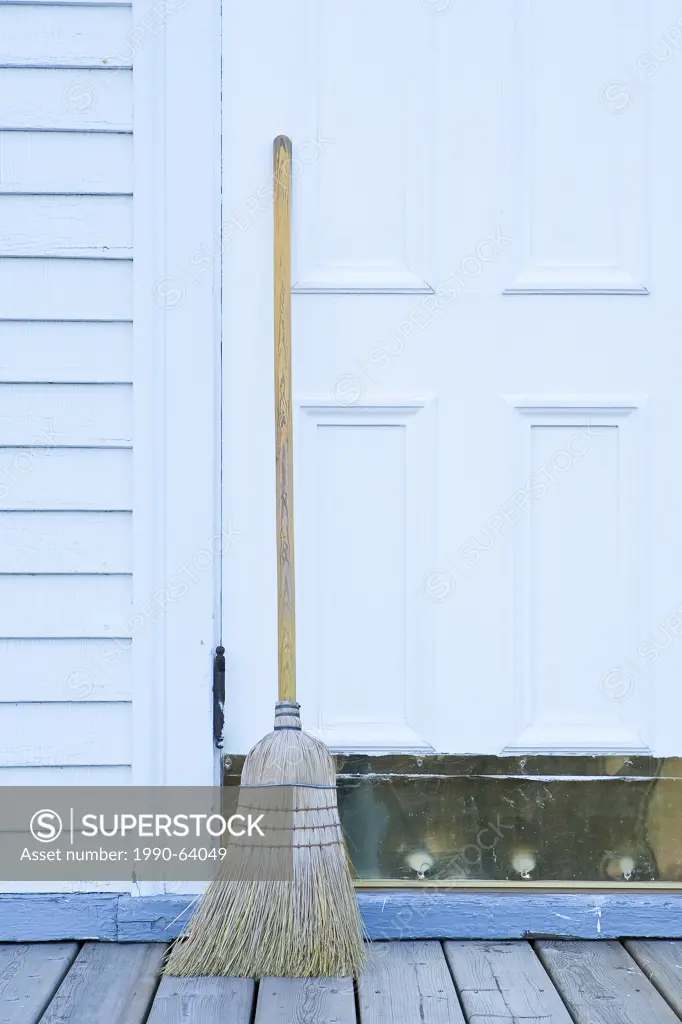 Broom propped up by rural Church door, Alberta, Canada