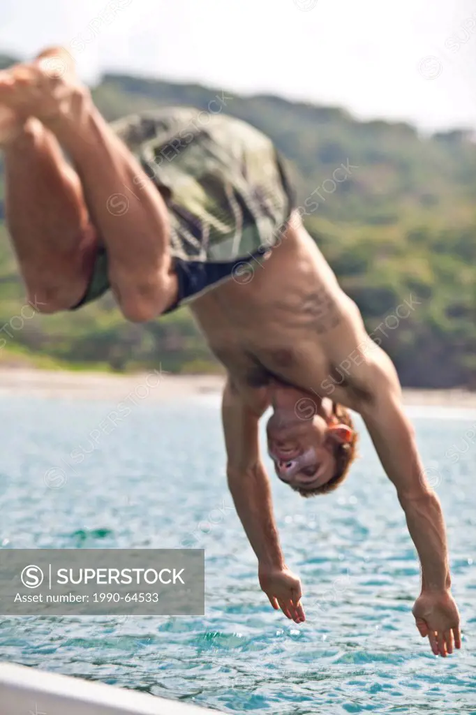 A young man dives off the a boat in San Juan del Sur, Nicaragua