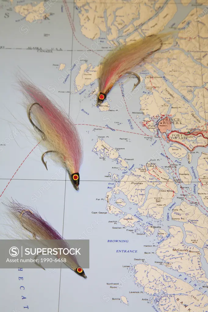 Salmon fishing concept image with bucktail flies and reel on map of British Columbia, Canada