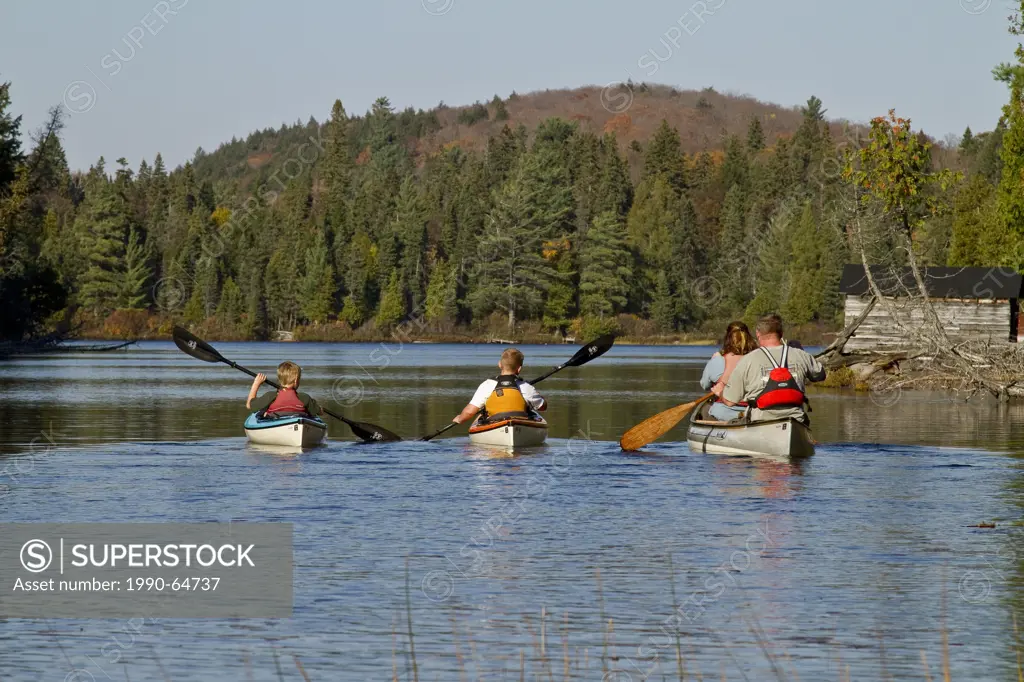 Family canoeing on Source Lake, Algonquin Park, Ontario, Canada.