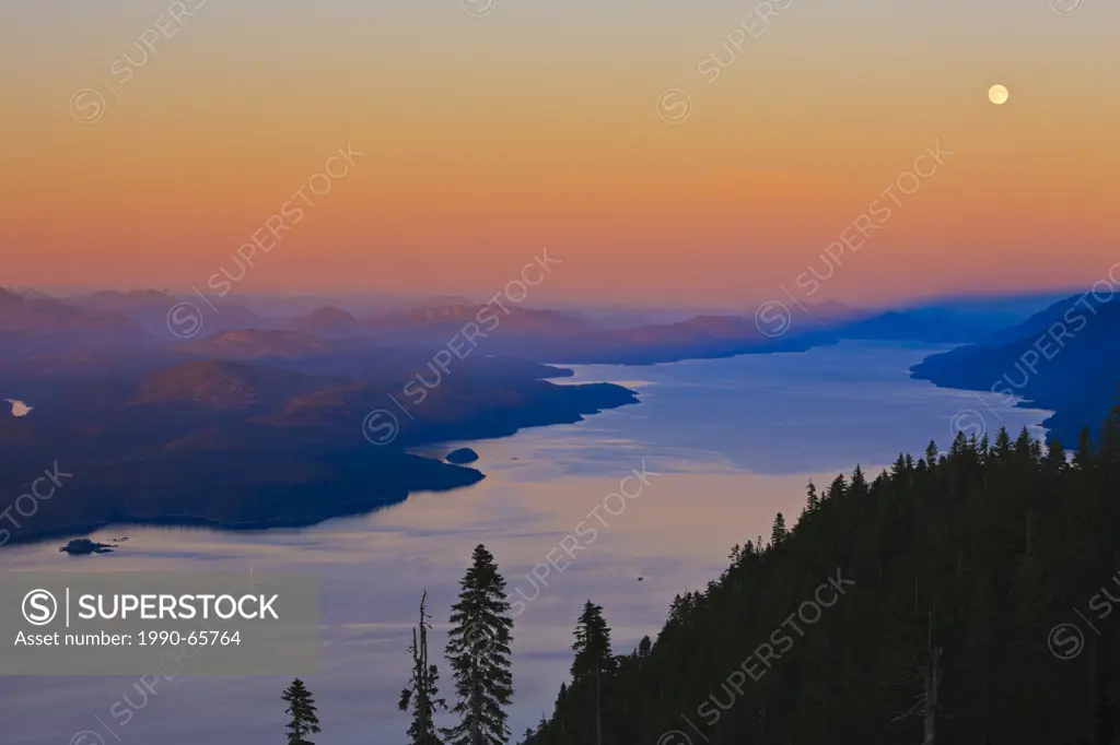 Aerial view over Johnstone Strait and Robson Bight, looking southeast after a beautiful soft sunset on a full moon twilight, Vancouver Island, British...