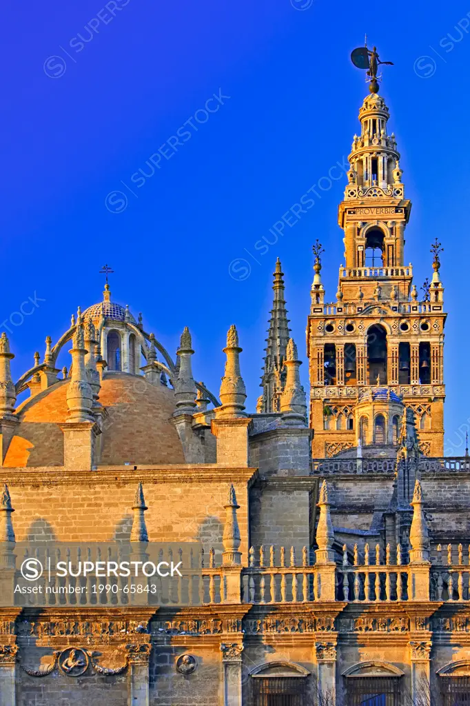 Seville Cathedral and La Giralda bell tower/minaret, a UNESCO World Heritage Site, seen from Plaza del Triunfo at Sunset, Santa Cruz District, City of...