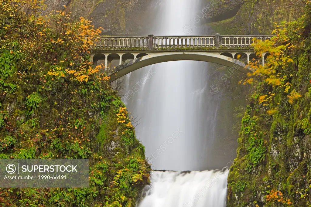 Tourist attraction Multnomah Falls, a 611_foot_tall roaring, awe_inspiring cascading waterfall in late fall with Benson Bridge, about 30 minutes east ...