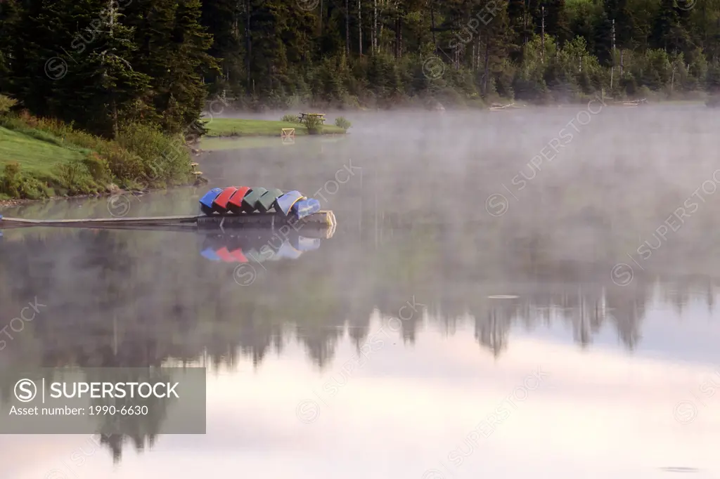 Canoes in fog on Bennett Lake, Fundy National Park, New Brunswick, Canada