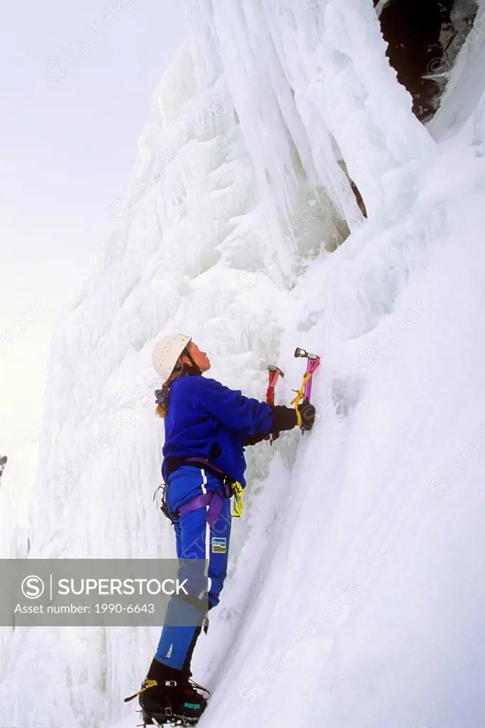 Ice Climber scaling iced wall of Baker´s Brook Pond, Gros Morne National Park, Newfoundland, Canada