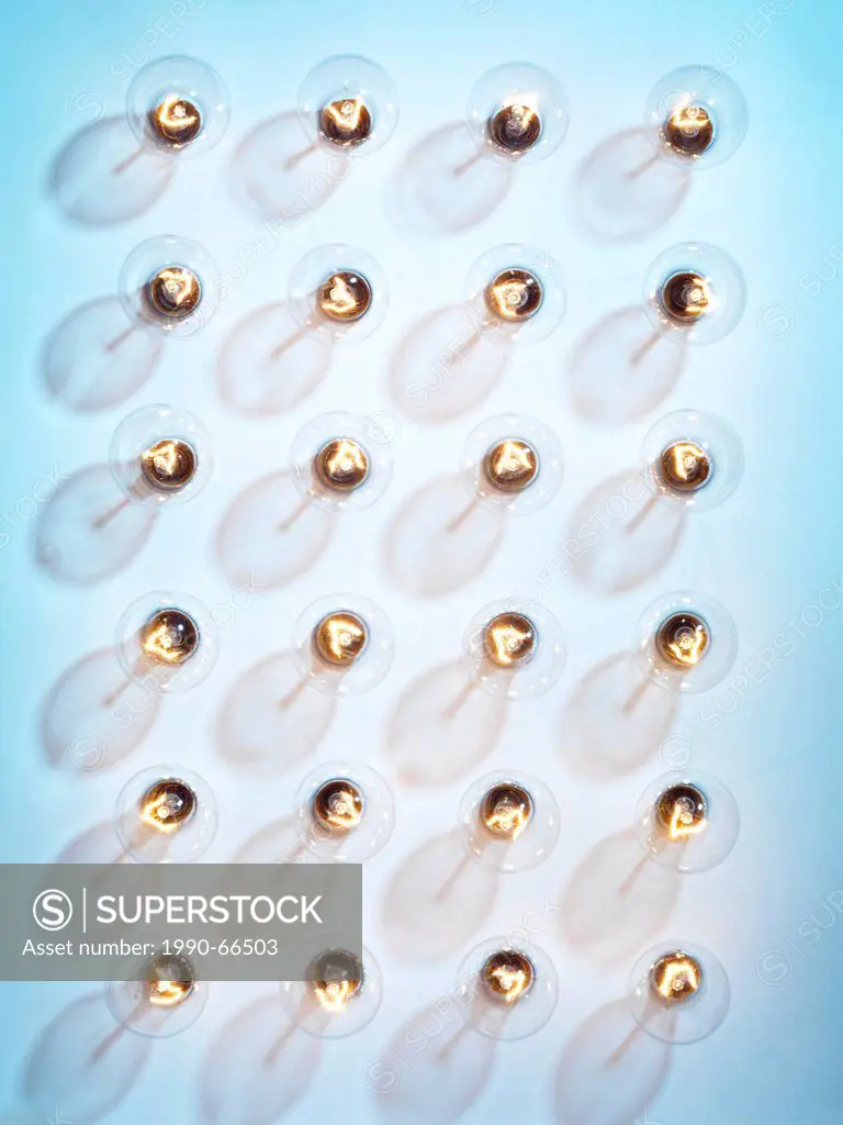 Group of lit incandescent tungsten light bulbs isolated on blue background