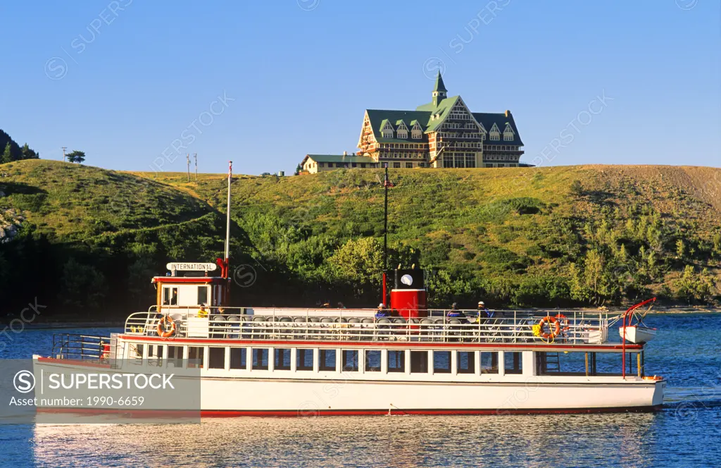 Tour boat in front of Prince of Wales Hotel in Waterton-Glacier International Peace Park, Alberta, Canada