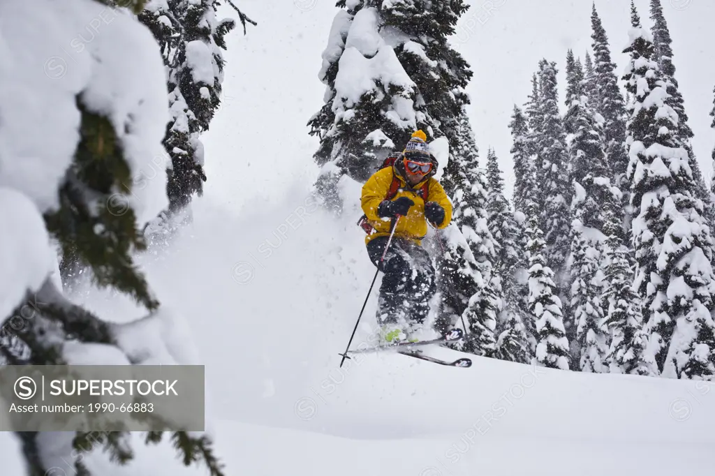 A man skiing deep powder while backcountry skiing at Sol Mountain, Monashee Backcountry, Revelstoke, BC