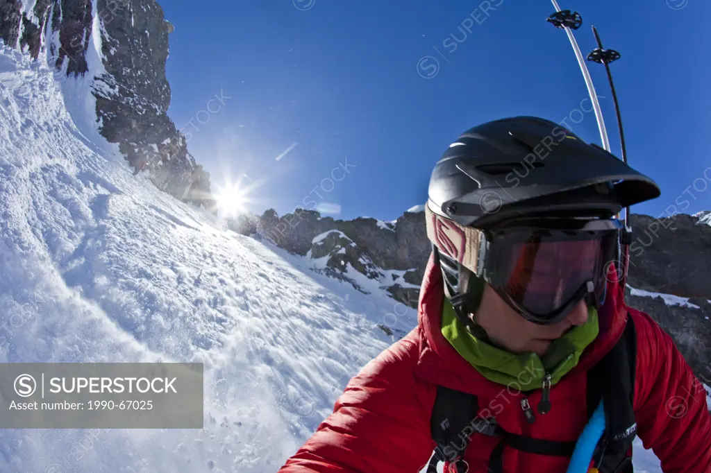 A male splitboarder captures a self portait pov while descending a steep couloir on Mt French, Peter Lougheed Provincial Park, Kananaskis, AB